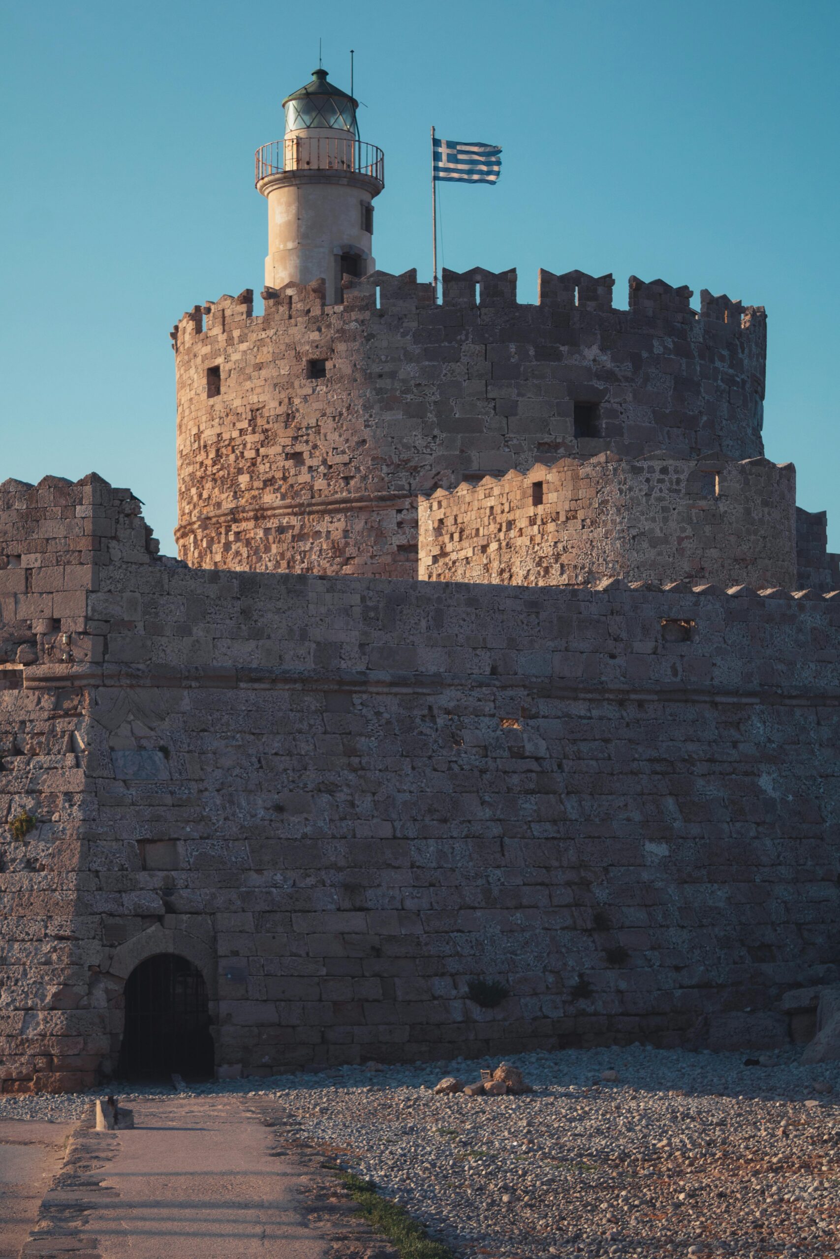 Explore the historic lighthouse atop the medieval fortress in Rhodes, Greece.